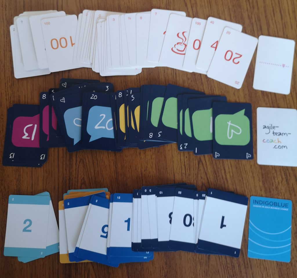 Various planning poker decks laid out on a table