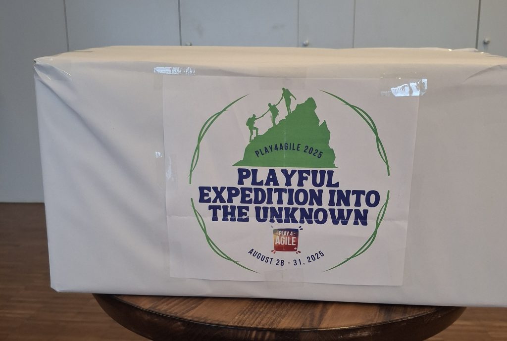 a box wrapped I white paper with the text 'playful expedition into the unknown"