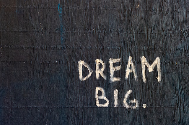 A blackboard with the text 'dream big' written in white