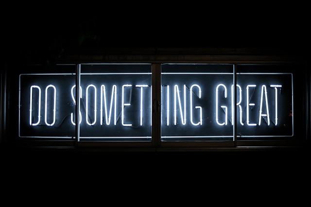 neon sign saying 'do something great'