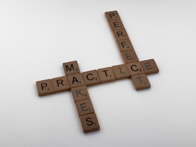 scrabble tiles spelling out 'practice makes perfect'